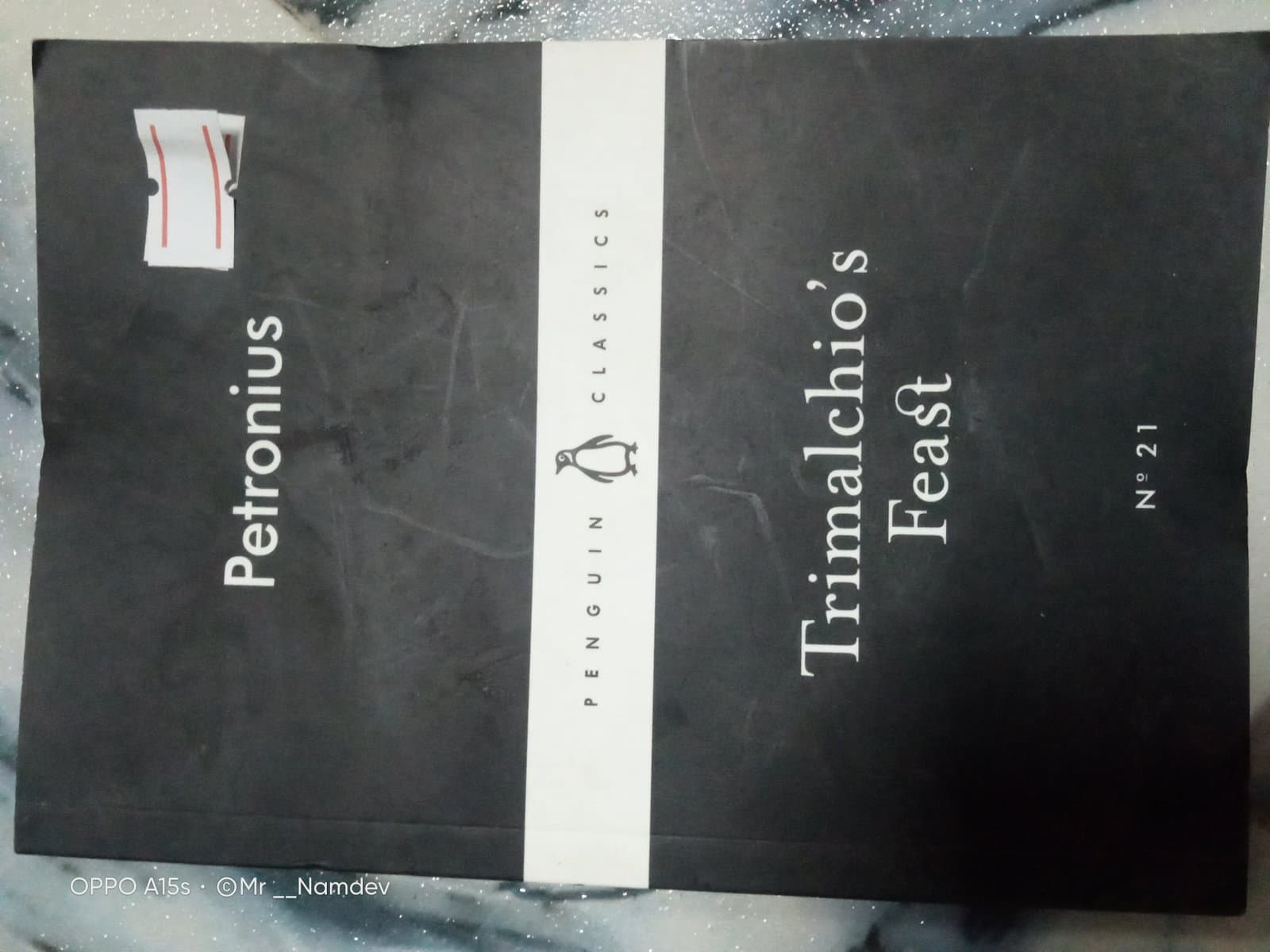 Cover of penguin classic set 19 books (trimalchios feast, how a ghastly stories was brought to light, the tinder box, the gate of the hundred sorrows, circle of hell, of street piemen, the nightingales are drunk, the wife of bath, the tell tale heart, the dharmmapada, it was snowing butterflies, the communist manifesto, the terrors of the night, to morrow, it was snowing butterflies, speaking of Shiva, antione, my dearest father, the life of a stupid man